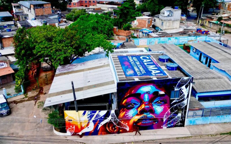 Telhado na Cidade de Deus diz: "Aqui tem crianças, sonhos e famílias"